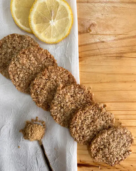 Fila de galletitas de limón y jengibre con rodajas de limón y jengibre en polvo